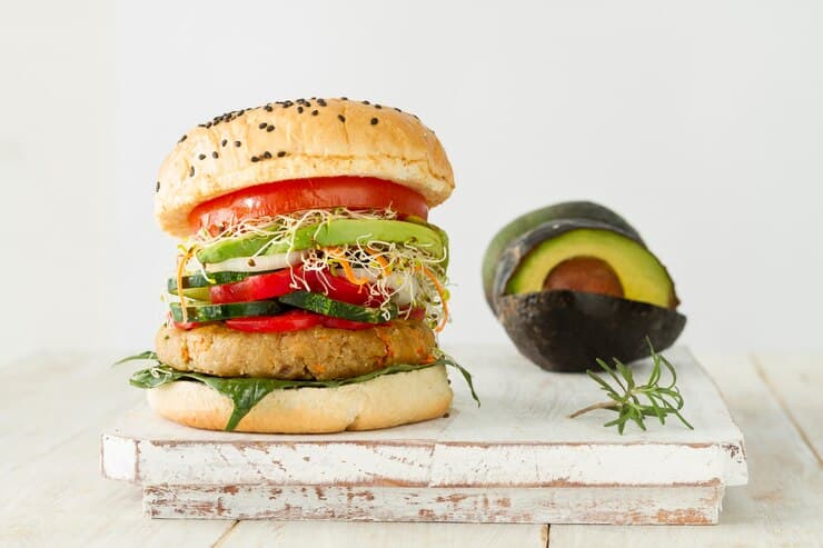 Burger and Avocado on a Wooden Board